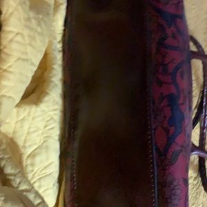 A beautiful navy, brown and burgundy floral purse. The blue stands out!